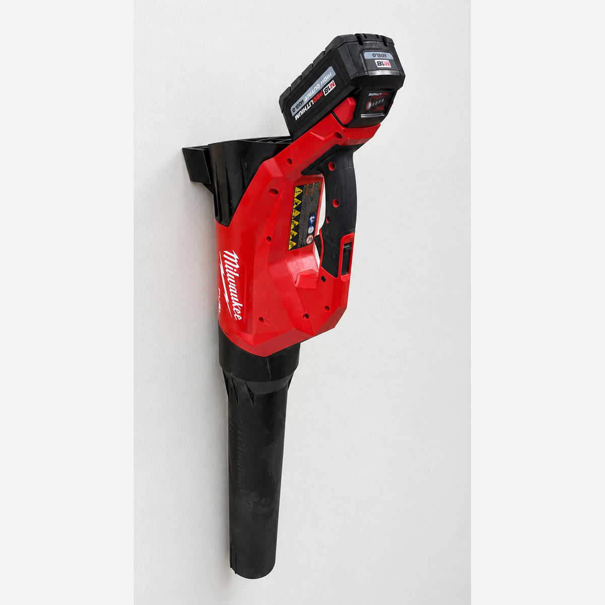 Milwaukee 3017-20 blower stored vertically in an M18 Blower Mount on a clean wall, with the nozzle pointing down.