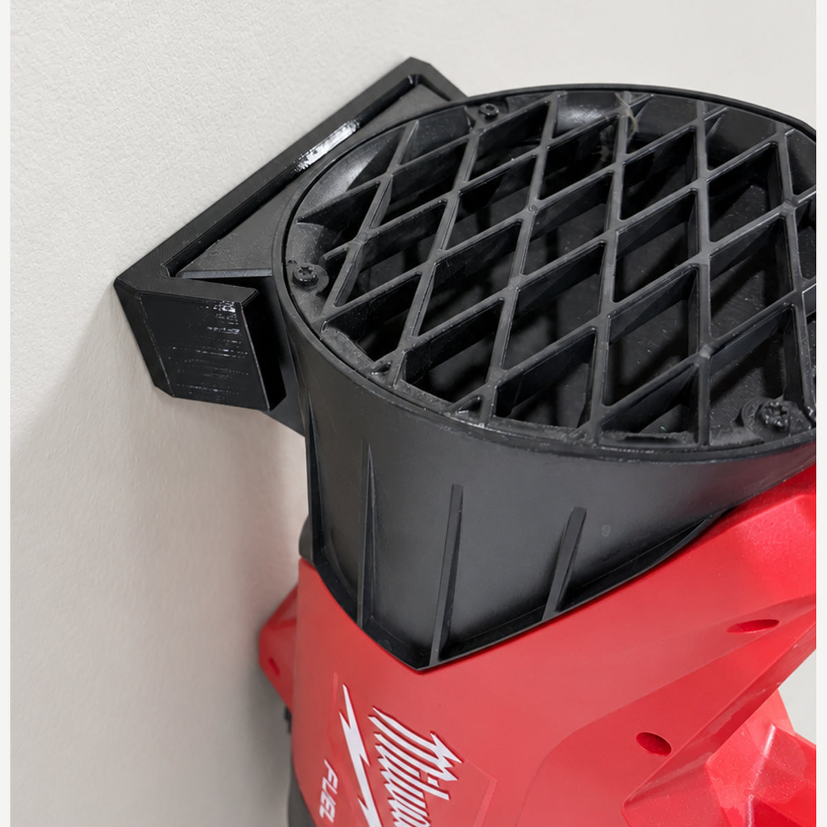 Close-up of the M18 Blower Mount supporting the Milwaukee 3017-20 blower beside its circular intake housing.